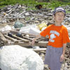 boy pointing at styrofoam on the beach