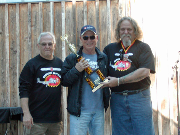 Auto Show committee chair Jim Grenwelge (left) and Mike 'Bone Daddy' Thomas present the Best of Show award to Santa Rosa's Bill Reinking for his 1965 Chevrolet Chevelle